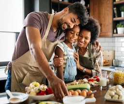 family preparing food in kitchen