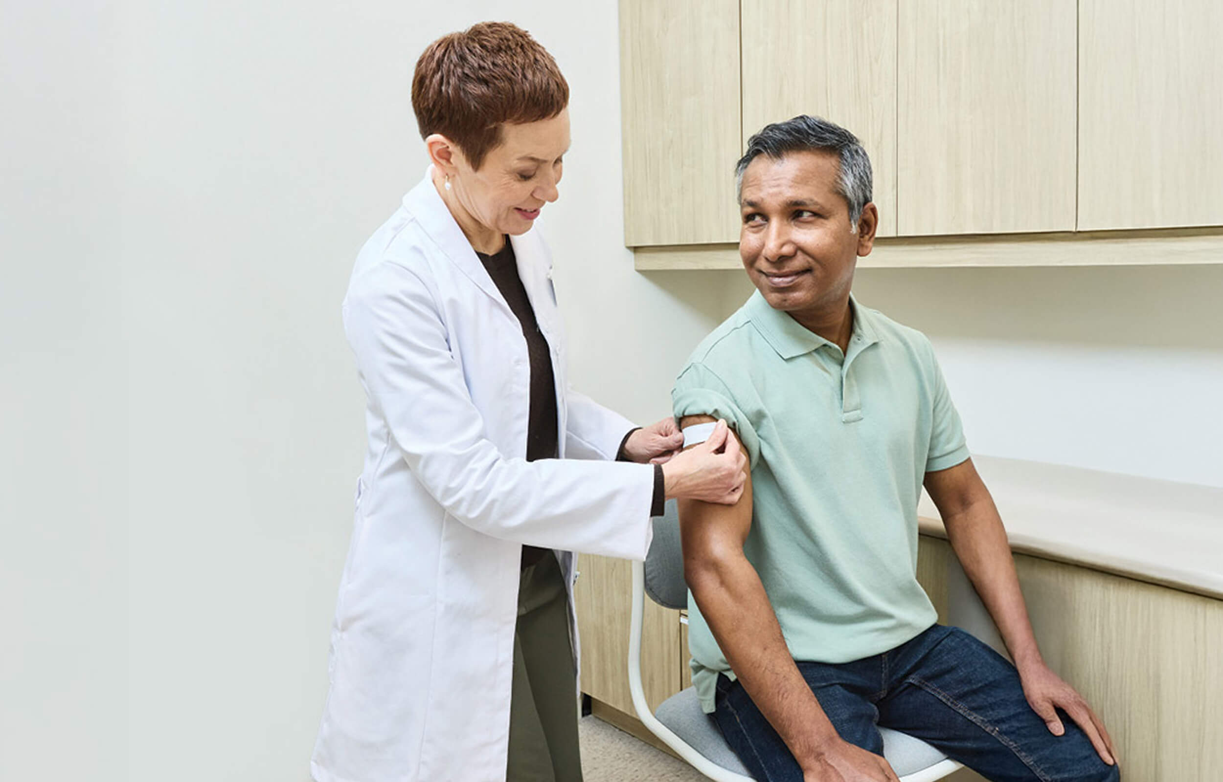 a doctor giving flu shot to patient